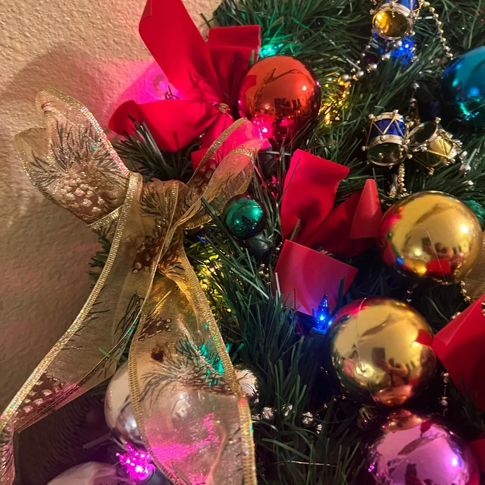 Festive Holiday Wreath with Gold Bow and Multicolor Ornaments